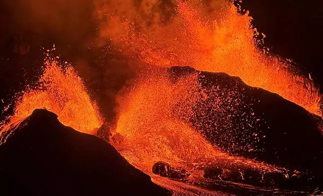 FILE - This image provided by the U.S. Geological Survey (USGS) shows evening views of lava fountaining from Haleumaumau Crater at the summit of Kilauea volcano inside Hawaii Volcanoes National Park, Hawaii., Feb. 11, 2025. (M. Patrick/U.S. Geological Survey via AP)