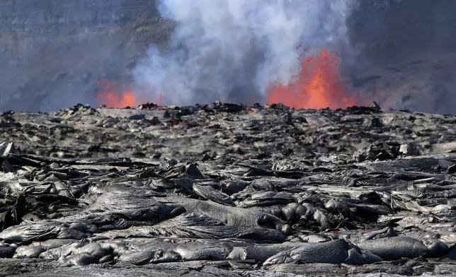 FILE - This image provided by the U.S. Geological Survey (USGS) shows two eruptive vents actively fountaining from the floor of Haleumaumau Crater as newly emplaced lava flows exhibit intense heat shimmer and residual glow in some of their cracks at the summit of Kilauea volcano inside Hawaii Volcanoes National Park, Hawaii, Feb. 4, 2025. (M. Zoeller/U.S. Geological Survey via AP, File)