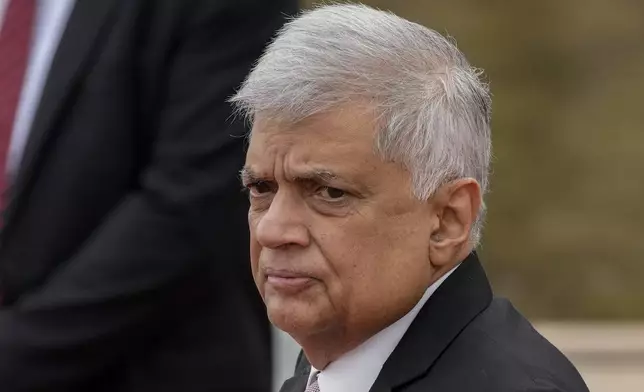 FILE -Sri Lankan president Ranil Wickremesinghe inspects a military guard of honour after arriving at the parliamentary complex in Colombo, Sri Lanka, Aug. 3, 2022. (AP Photo/Eranga Jayawardena, File)