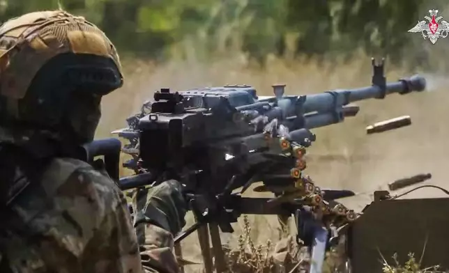 In this photo taken from video distributed by Russian Defense Ministry Press Service on Sunday, Aug. 17, 2025, a Russian soldier fires during a practice at a training ground on an undisclosed location in Ukraine. (Russian Defense Ministry Press Service via AP)