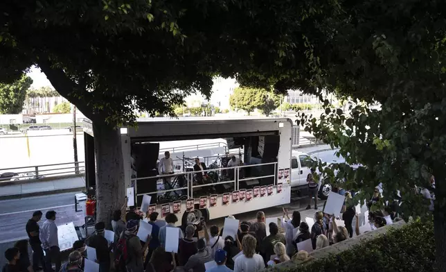 Fellow musicians of Rami Othmane, a Tunisian man detained at the U.S. Immigration and Customs Enforcement facility, perform during a rally outside the facility in Los Angeles Friday, July 25, 2025. (AP Photo/Jae C. Hong)