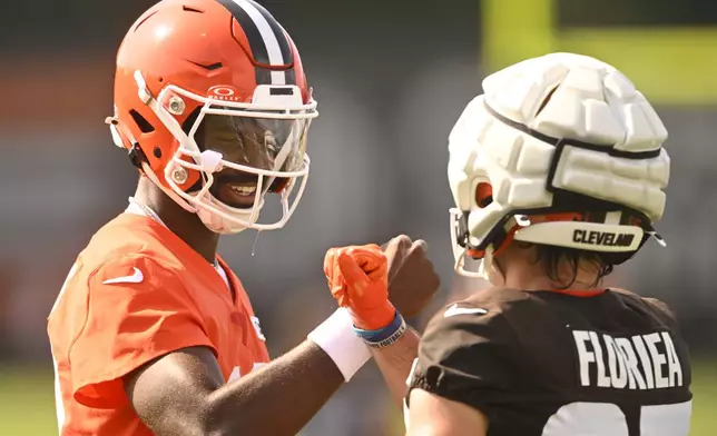 Cleveland Browns quarterback Shedeur Sanders (12) celebrates after completing a pass to wide receiver Luke Floriea (37) during a practice at the team's NFL football training camp, Saturday, July 26, 2025, in Berea, Ohio. (AP Photo/David Richard)