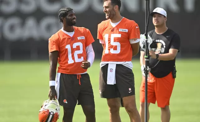 Cleveland Browns quarterback Shedeur Sanders (12) talks to quarterback Joe Flacco (15) during a practice at the team's NFL football training camp Saturday, July 26, 2025, in Berea, Ohio. (AP Photo/David Richard)