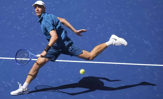 Denis Shapovalov, of Canada, returns a shot against Jannik Sinner, of Italy, during the third round of the U.S. Open tennis championships, Saturday, Aug. 30, 2025, in New York. (AP Photo/Kirsty Wigglesworth)