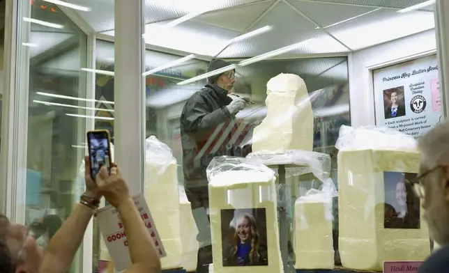Sculptor Gerry Kulzer carves the likeness of Malorie Thorson, this year's Princess Kay of the Milky Way, out of a block of butter at the Minnesota State Fair, Thursday, Aug. 21, 2025 in Falcon Heights, Minn. (AP Photo/Mark Vancleave)