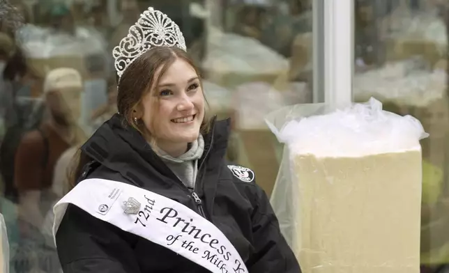 Princess Kay of the Milky Way Malorie Thorson sits in a 40-degree rotating cooler for her likeness to be carved from a 90-pound block of butter by sculptor Gerry Kulzer at the Minnesota State Fair on Thursday, Aug. 21, 2025 in Falcon Heights, Minn. (AP Photo/Mark Vancleave)