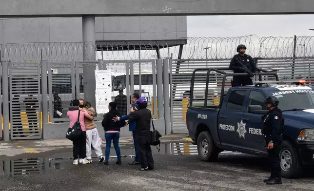 Israel Vallarta, second from left, facing camera, gets hugs from his family as he leaves Altiplano maximum security prison after a judge ordered his release in Almoloya, near Mexico City, Friday, Aug. 1, 2025. Vallarta served almost 20 years behind bars for being the leader of an kidnapping ring before a judge ruled on Thursday that the evidence didn't support the charges against him. (AP Photo/Haaron Alvarez)