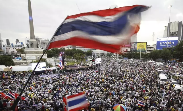 Protesters waving Thailand flags gather at Victory Monument demanding Prime Minister Paetongtarn Shinawatra resign in Bangkok, Thailand, Saturday, Aug. 2, 2025. (AP Photo/Tadchakorn Kitchaiphon)