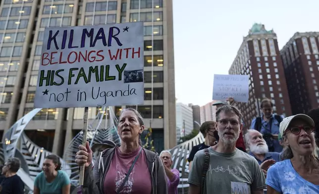People attend a protest rally at the Immigration and Customs Enforcement field office in Baltimore, Monday, Aug. 25, 2025, to support Kilmar Abrego Garciab. (AP Photo/Stephanie Scarbrough)