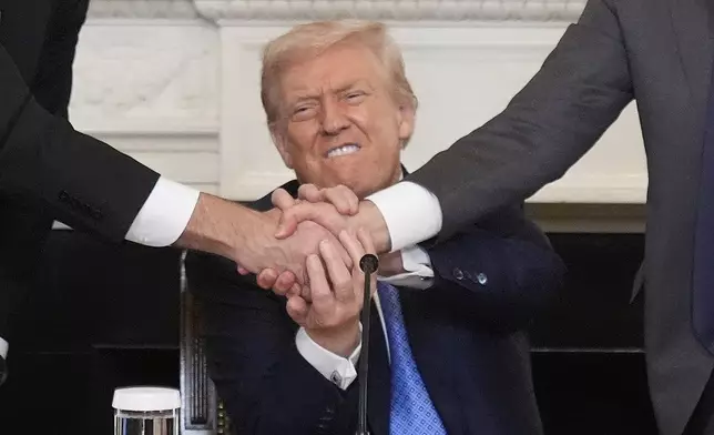 President Donald Trump, center, shakes hands with Armenian Prime Minister Nikol Pashinyan, right, and Azerbaijan President Ilham Aliyev during a trilateral signing ceremony in the State Dining Room of the White House, Friday, Aug. 8, 2025, in Washington. (AP Photo/Mark Schiefelbein)