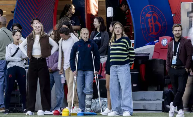 Bay FC forward Penelope Hocking, center on crutches, stands on the sideline before a NWSL soccer match against San Diego Wave FC in San Jose, Calif., Saturday, Aug. 16, 2025. (Stephen Lam/San Francisco Chronicle via AP)