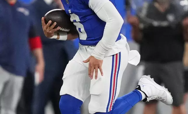 New York Giants quarterback Jaxson Dart (6) carries the all against the New England Patriots during the first quarter of an NFL football game, Thursday, Aug. 21, 2025, in East Rutherford, N.J. (AP Photo/Yuki Iwamura)