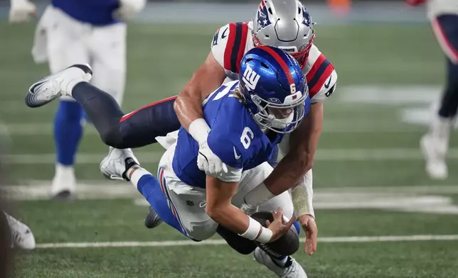 New York Giants quarterback Jaxson Dart (6) is tackled by New England Patriots linebacker Jack Gibbens (51) during the first quarter of an NFL football game, Thursday, Aug. 21, 2025, in East Rutherford, N.J. (AP Photo/Frank Franklin II)