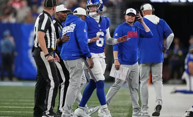 New York Giants quarterback Jaxson Dart (6) is walked off the field after being tackled by the New England Patriots during the first quarter of an NFL football game, Thursday, Aug. 21, 2025, in East Rutherford, N.J. (AP Photo/Yuki Iwamura)