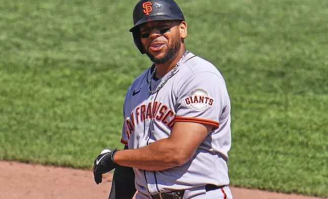 San Francisco Giants' Dominic Smith celebrates as he stands on second base after driving in a run with a double off Pittsburgh Pirates pitcher Dennis Santana during the ninth inning of a baseball game in Pittsburgh, Wednesday, Aug. 6, 2025. (AP Photo/Gene J. Puskar)