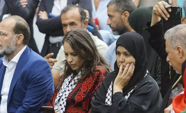 The mother, center right, of 19-year-old Palestinian woman Marah Abu Zhuri attends her funeral in Pontesserchio, near Pisa, Italy, Wednesday Aug. 20, 2025, who died there after being evacuated from Gaza. (Alessandro La Rocca/LaPresse via AP)