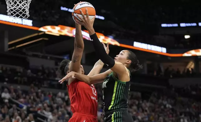 Minnesota Lynx forward Napheesa Collier (24) goes up for a shot as Indiana Fever forward Damiris Dantas (12) defends during the first half of a WNBA basketball game Sunday, Aug. 24, 2025, in Minneapolis. (AP Photo/Abbie Parr)