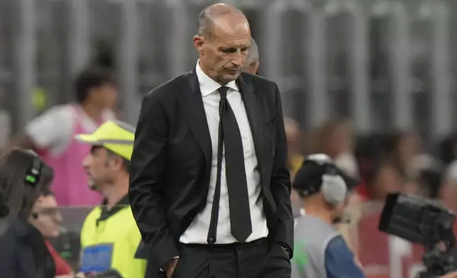 AC Milan's head coach Massimiliano Allegri, right, reacts at the end of a Serie A soccer match between AC Milan and Cremonese, at the San Siro stadium in Milan, Italy, Saturday, Aug. 23, 2025. (AP Photo/Luca Bruno)