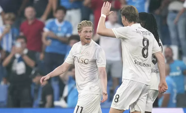 Napoli's Kevin De Bruyne celebrates with teammate Scott McTominay after scoring during the Italian Serie A soccer match between Sassuolo and Napoli at the Mapei Stadium Città del Tricolore in Reggio Emilia, Italy, Saturday, Aug. 23, 2025. (Massimo Paolone/LaPresse via AP)