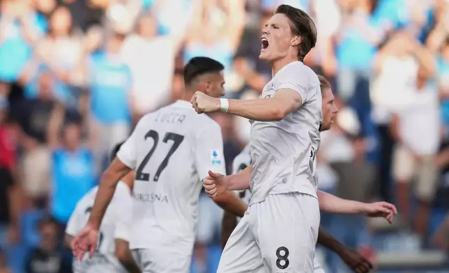 Napoli's Scott Mc Tominay celebrates scoring their side's first goal of the game during the Italian Serie A soccer match between Sassuolo and Napoli at the Mapei Stadium Città del Tricolore in Reggio Emilia, Italy, Saturday, Aug. 23, 2025. (Massimo Paolone/LaPresse via AP)