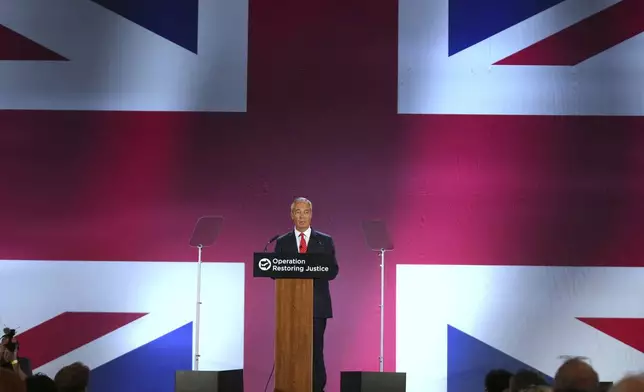 British Reform party leader Nigel Farage addresses journalists during a press conference in a hangar at Oxford Airport in Kidlington, England, Tuesday, Aug. 26, 2025.(AP Photo/Joanna Chan)