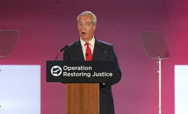 British Reform party leader Nigel Farage addresses journalists during a press conference in a hangar at Oxford Airport in Kidlington, England, Tuesday, Aug. 26, 2025.(AP Photo/Joanna Chan)