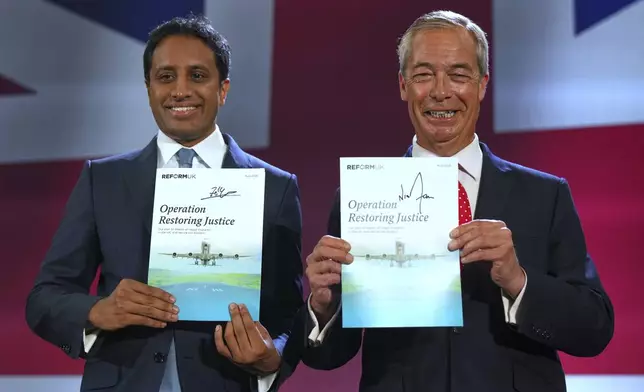 British Reform party leader Nigel Farage and Zia Yusuf, left, show the program Operation Restoring Justice during a press conference in a hangar at Oxford Airport in Kidlington, England, Tuesday, Aug. 26, 2025.(AP Photo/Joanna Chan)