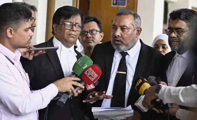 Public Prosecutor Muhammad Tariqul Islam, wearing a necktie, speaks to the media following a court hearing in the corruption case against former British Minister Tulip Siddiq at the Dhaka Special Judge Court-4, in Dhaka, Bangladesh, Wednesday, Aug. 13, 2025. (AP Photo/Mahmud Hossain Opu)
