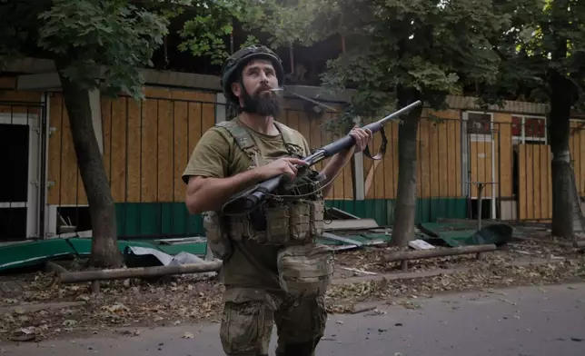 A Ukrainian soldier gets ready to fire at Russian FPV drones in the town of Kostiantynivka, the site of heavy battles with Russian troops in the Donetsk region, Ukraine, on Sunday, Aug. 24, 2025. (AP Photo/Yevhen Titov)