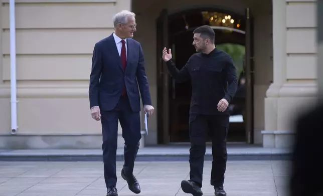 Norway's Prime Minister Jonas Gahr Store, left, and Ukrainian President Volodymyr Zelenskyy talk during their meeting in Kyiv, Ukraine, Monday, Aug. 25, 2025. (AP Photo/Efrem Lukatsky)