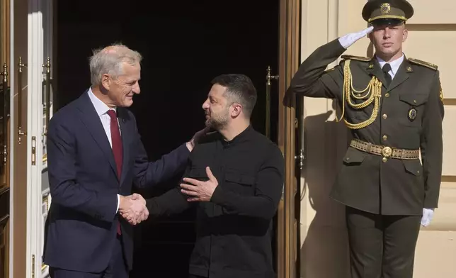 Norway's Prime Minister Jonas Gahr Store, left, shakes hands with Ukrainian President Volodymyr Zelenskyy during their meeting in Kyiv, Ukraine, Monday, Aug. 25, 2025. (AP Photo/Efrem Lukatsky)