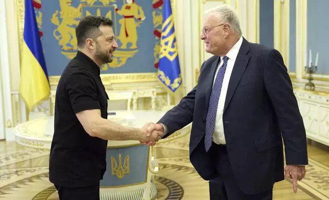 In this photo provided by the Ukrainian Presidential Press Office, Ukrainian President Volodymyr Zelenskyy, left, shakes hands with Keith Kellogg, Trump's special envoy to Ukraine in Kyiv, Ukraine, Monday, Aug. 25, 2025. (Ukrainian Presidential Press Office via AP)