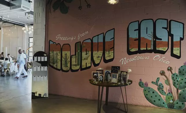 Family photos sit on display in the entrance to Mojave East before a wedding Saturday, Aug. 23, 2025, in Newtown, Ohio. (AP Photo/Joshua A. Bickel)
