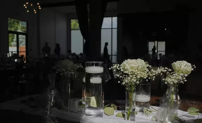 Sunlight falls on table decorations as guests arrive before a wedding Saturday, Aug. 23, 2025, in Newtown, Ohio. (AP Photo/Joshua A. Bickel)