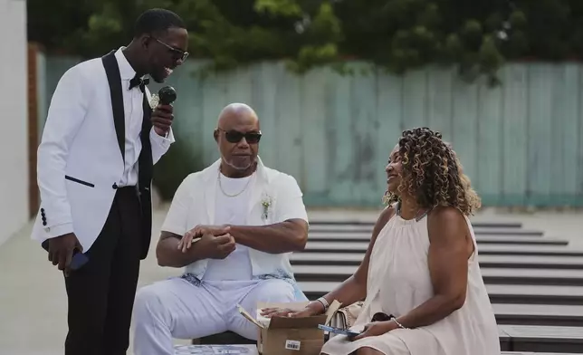 Tyler Jones, left, chats with family members before his wedding Saturday, Aug. 23, 2025, in Newtown, Ohio. (AP Photo/Joshua A. Bickel)