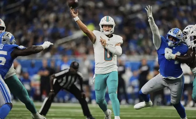 Miami Dolphins quarterback Zach Wilson (0) passes during the first half of an NFL preseason football game against the Detroit Lions Saturday, Aug. 16, 2025, in Detroit. (AP Photo/Ryan Sun)