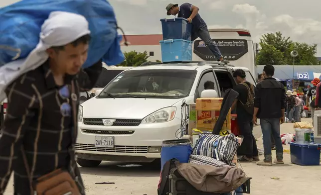 Migrant workers re-enter Cambodia through the Daung International Border Check Point between Cambodia and Thailand, in in Kamrieng, on Wednesday, Aug. 6, 2025. (AP Photo/Anton L. Delgado)