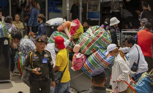 Military policemen patrol the main road of Kamrieng as migrant workers re-enter Cambodia through the Daung International Border Check Point between Cambodia and Thailand on Wednesday, Aug. 6, 2025. (AP Photo/Anton L. Delgado)