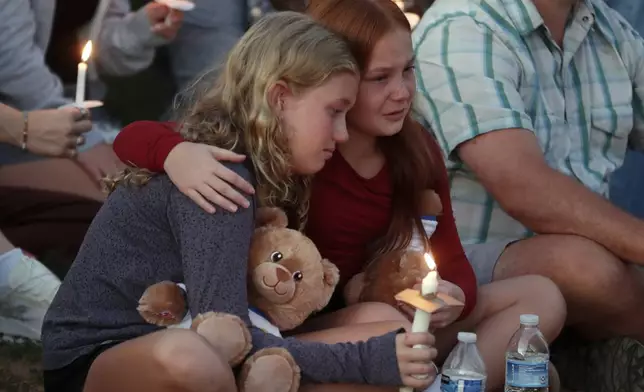 People gather at a vigil at Lynnhurst Park after a shooting at the Annunciation Catholic School, Wednesday, Aug. 27, 2025, in Minneapolis. (AP Photo/Bruce Kluckhohn)