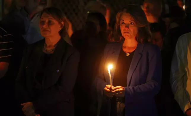 People gather at a vigil at Lynnhurst Park after a shooting at the Annunciation Catholic School Wednesday, Aug. 27, 2025, in Minneapolis. (AP Photo/Bruce Kluckhohn)