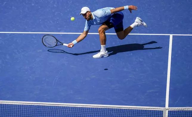 Novak Djokovic, of Serbia, returns a shot to Zachary Svajda, of the United States, during the second round of the U.S. Open tennis championships, Wednesday, Aug. 27, 2025, in New York. (AP Photo/Kirsty Wigglesworth)