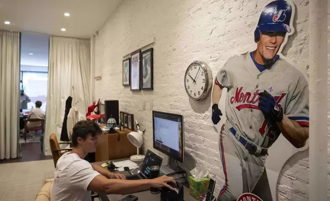 An employee works at Flower Shop, Thursday, July 30, 2025, in New York. (AP Photo/Yuki Iwamura)