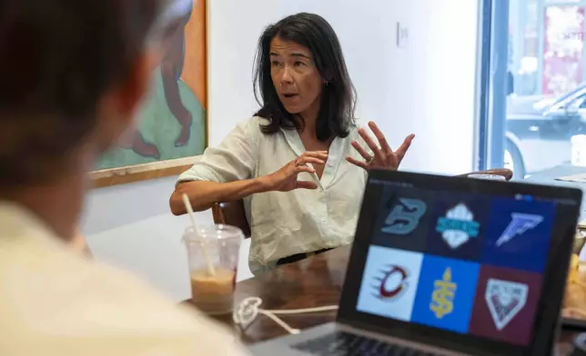 Flower Shop's co-founder and Chief Executive Officer Mary Lou Bunn speaks as sketches of team logos for Professional Women's Hockey League are shown on a computer screen, Thursday, July 30, 2025, in New York. (AP Photo/Yuki Iwamura)