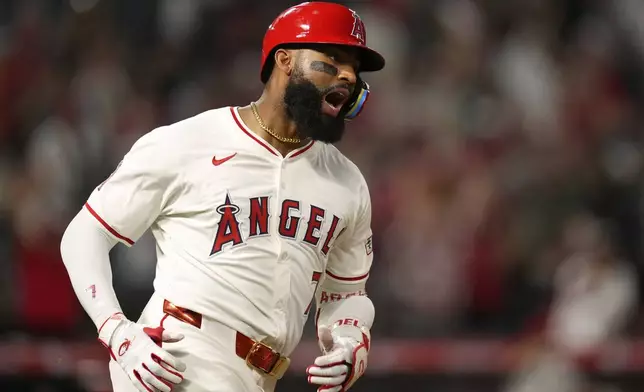 Los Angeles Angels' Jo Adell celebrates after hitting a solo home run during the eighth inning of a baseball game against the Cincinnati Reds, Tuesday, Aug. 19, 2025, in Anaheim, Calif. (AP Photo/Mark J. Terrill)