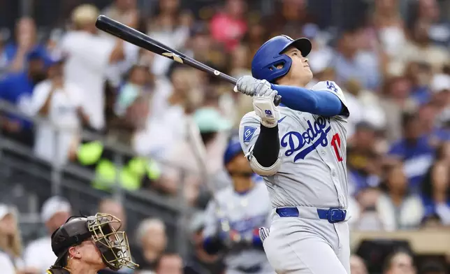Los Angeles Dodgers' Shohei Ohtani flys out to center field against the San Diego Padres in the sixth inning of a baseball game Saturday, Aug. 23, 2025, in San Diego. (AP Photo/Derrick Tuskan)