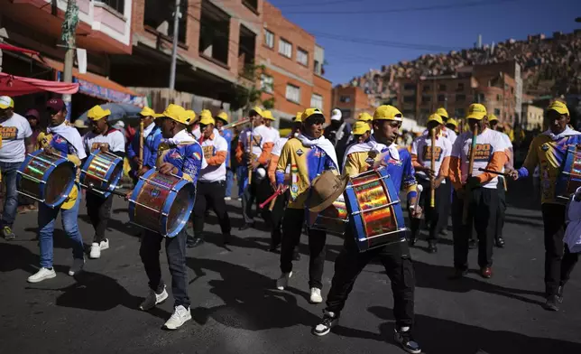 Supporters of Bolivian presidential candidate Samuel Doria Medina play drum during a campaign rally five days ahead of presidential elections, in La Paz, Bolivia, Tuesday, Aug. 12, 2025. (AP Photo/Natacha Pisarenko)