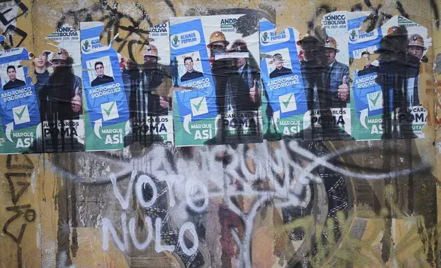 Campaign posters of presidential candidate Andronico Rodriguez cover a wall prior to Sunday's presidential and legislative elections in La Paz, Bolivia, Thursday, Aug. 14, 2025. (AP Photo/Natacha Pisarenko)