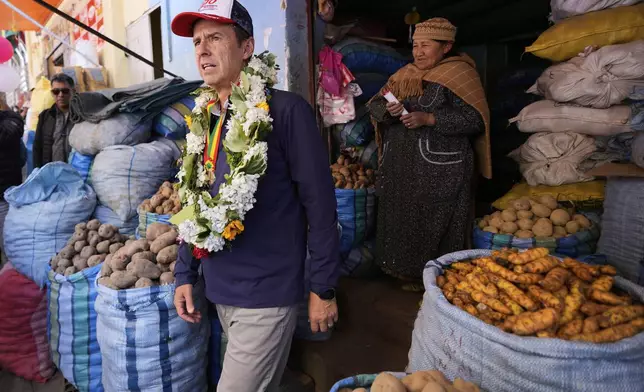 Bolivian presidential candidate Jorge "Tuto" Quiroga tours a market while campaigning ahead of the upcoming presidential election, in La Paz, Bolivia, Thursday, Aug. 7, 2025. (AP Photo/Juan Karita)