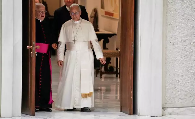 Pope Leo XIV talks to Monsignor Leonardo Sapienza as he arrives in the Paul IV hall on the occasion of the weekly general audience at the Vatican, Wednesday, Aug. 27, 2025. (AP Photo/Gregorio Borgia)