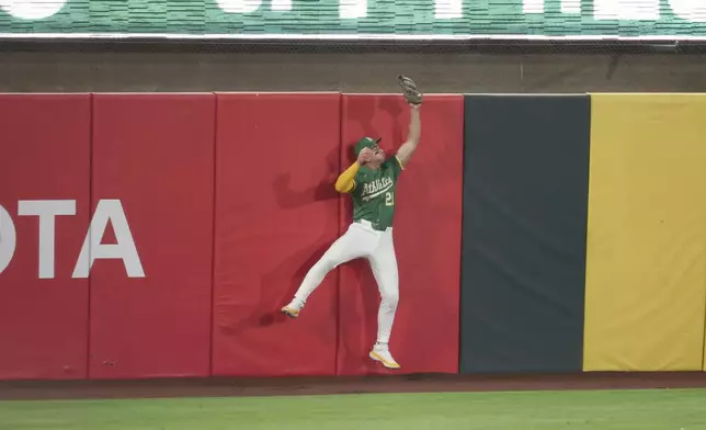 Athletics outfielder Tyler Soderstrom catches a ball hit by Texas Rangers' Michael Helman, not shown, during the ninth inning of a baseball game Friday, Aug. 29, 2025, in West Sacramento, Calif. (AP Photo/Sara Nevis)